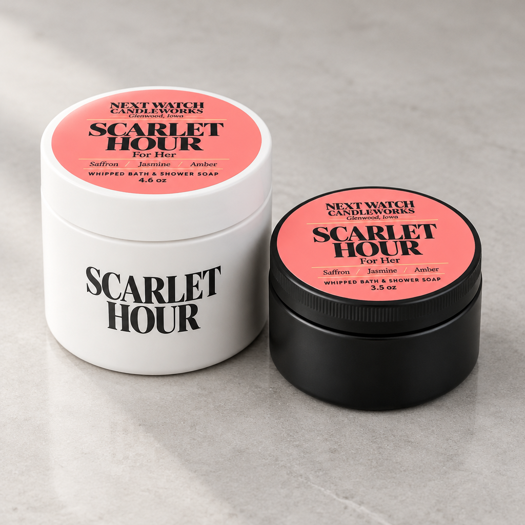 Two product containers from Next Watch Candle Works on a light gray stone surface: a large white jar labeled Scarlet Hour For Her and a smaller black jar labeled Scarlet Hour For Her.